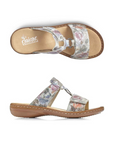 Pair of Pale floral print slide sandals with two Velcro straps, textured details and medallion accent, tan Rieker logo'd footbed and brown outsole.