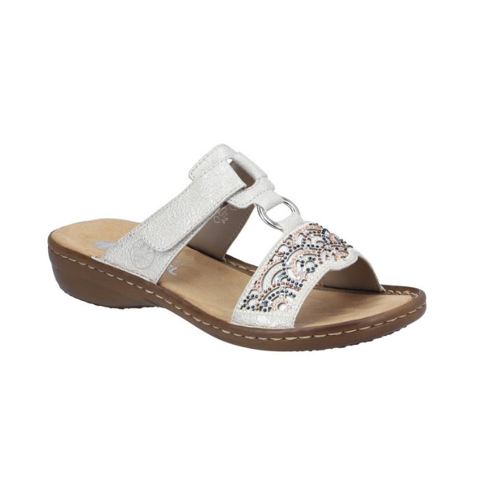 Slide Sandal in silver with decorative beading, Velcro strap, decorative ring medallion, tan Rieker logo'd footbed and brown outsole.