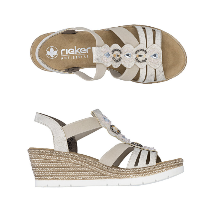 Pair of gold slingback strappy wedge sandals with decorative beaded straps, tan Rieker logo'd footbed, faux espadrille midsole and white outsole. 