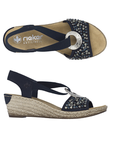 Pair of Navy slingback wedge sandals with  beaded embellishments, silver medallion, faux espadrille midsole and a tan Rieker logo'd footbed.