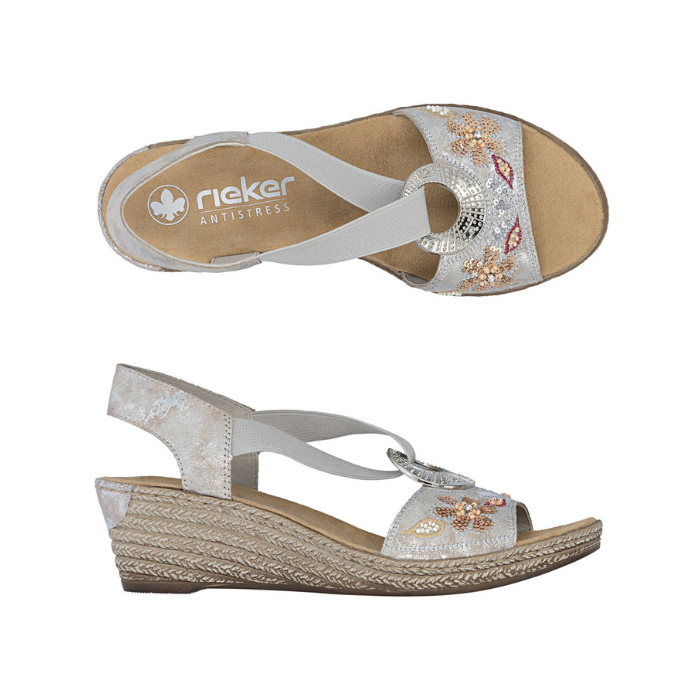 Pair of Silver wedge sandals with floral embellishments, silver medallion, tan Rieker logo'd footbed and faux espadrille midsole.