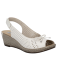 White wedge slingback peep toe sandal with perforated upper, small decorative bow on vamp, faux espadrille midsole and a brown outsole.