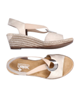 Pair of Gold slingback faux espadrille wedge sandals with elastic side straps, silver medallion, tan Rieker logo'd footbed and brown outsole.