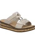 Beige slide sandal with decorative embellishments, faux cork midsole, and tan Rieker logo'd footbed.