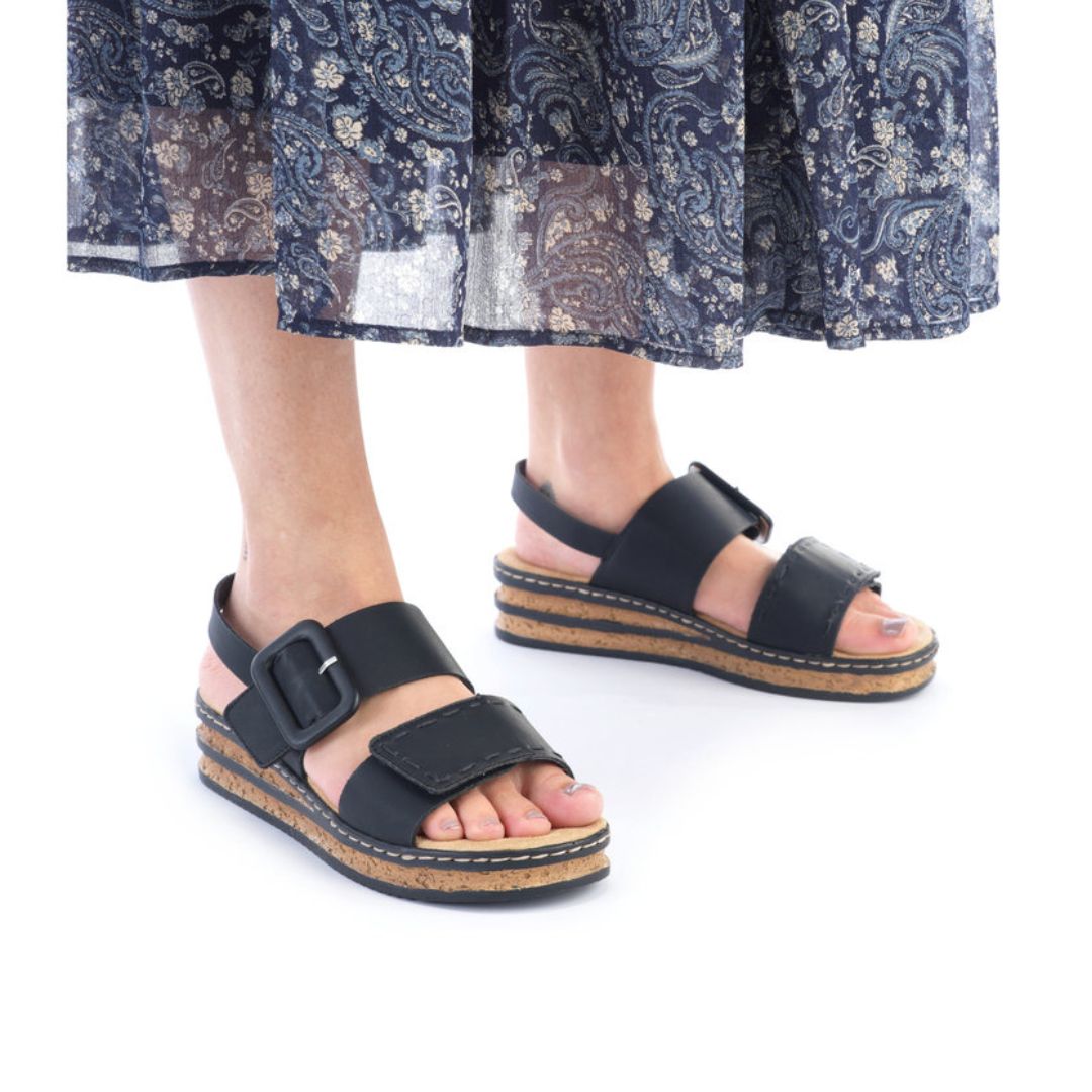 Model wearing black Backstrap Sandals paired with a patterned skirt.
