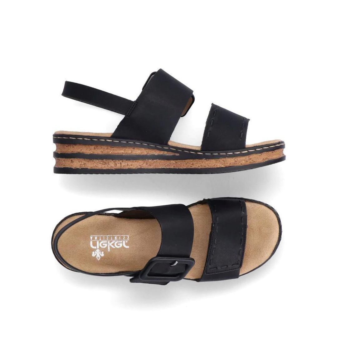Pair of Black Backstrap Sandals with a stylish buckle, two Velcro straps, tan Rieker logo'd footbed, faux cork layered midsole and black outsole.
