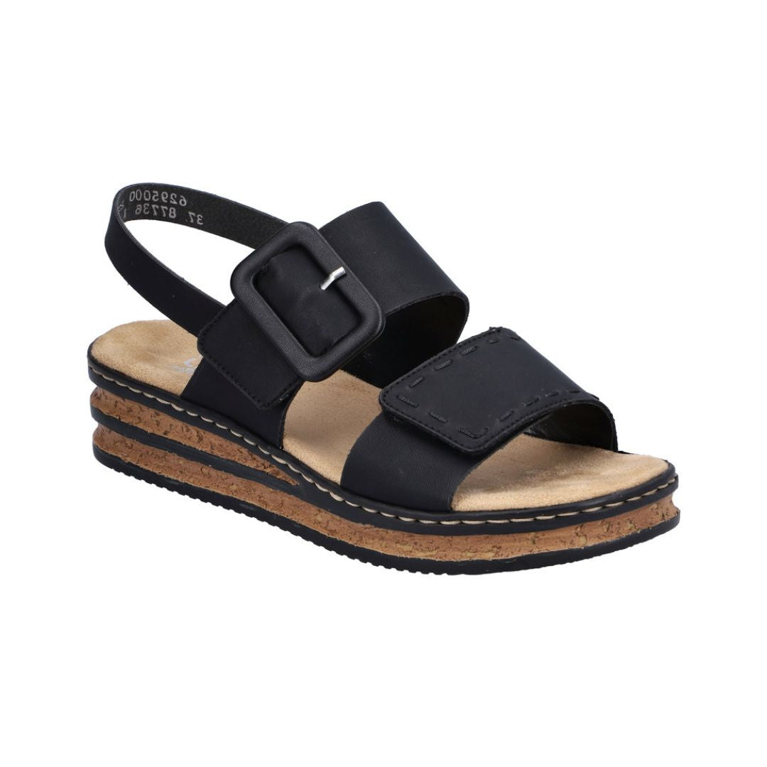 Black Backstrap Sandal with a stylish buckle, two Velcro straps, tan Rieker logo'd footbed, faux cork layered midsole and black outsole.