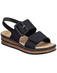 Black Backstrap Sandal with a stylish buckle, two Velcro straps, tan Rieker logo'd footbed, faux cork layered midsole and black outsole.