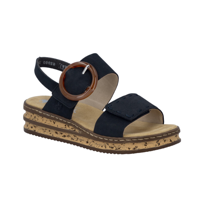 Navy Backstrap Sandal with a stylish circle buckle, two Velcro straps, tan Rieker logo'd footbed, faux cork layered midsole and brown outsole.