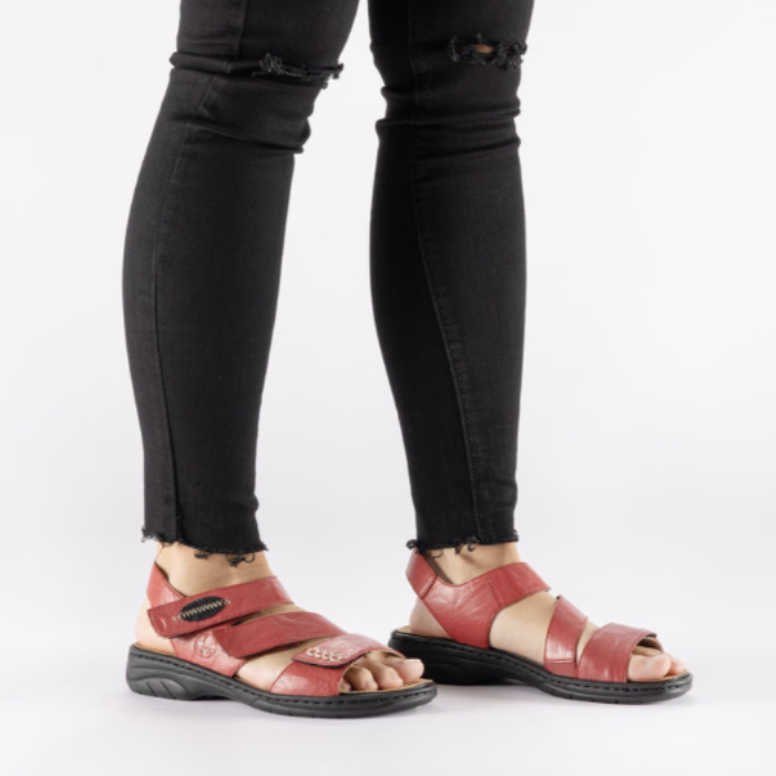 Model wearing red Backstrap Leather Sandals styled with jeans.