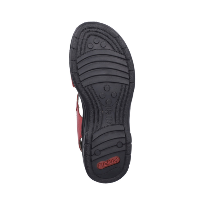 Treaded black rubber outsole of sandal with lines and circle pattern and red Rieker logo on heel.