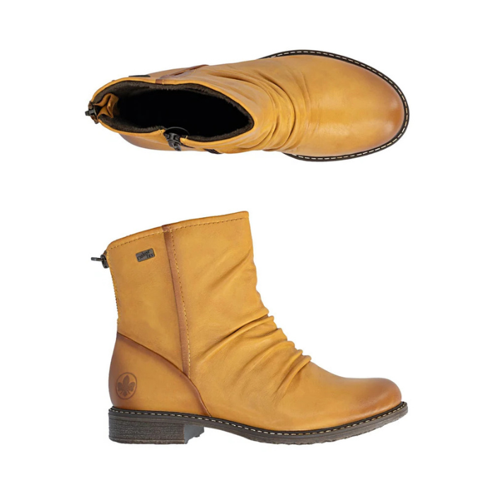 Pair of Mustard yellow ankle boots with ruching over toe, burnishing finish and brown outsole.
