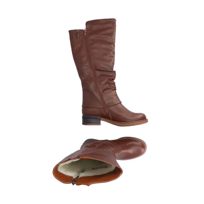Brown tall boot with low heel and outside zipper detail. Boot has functional inside zipper and white faux fur lining.