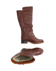 Brown tall boot with low heel and outside zipper detail. Boot has functional inside zipper and white faux fur lining.