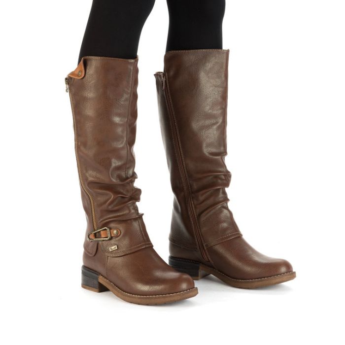 Legs wearing leggings and brown tall boot with low heel and outside zipper detail..