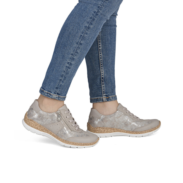 Beige with shimmery section sneakers with faux cork midsole worn with blue jeans.