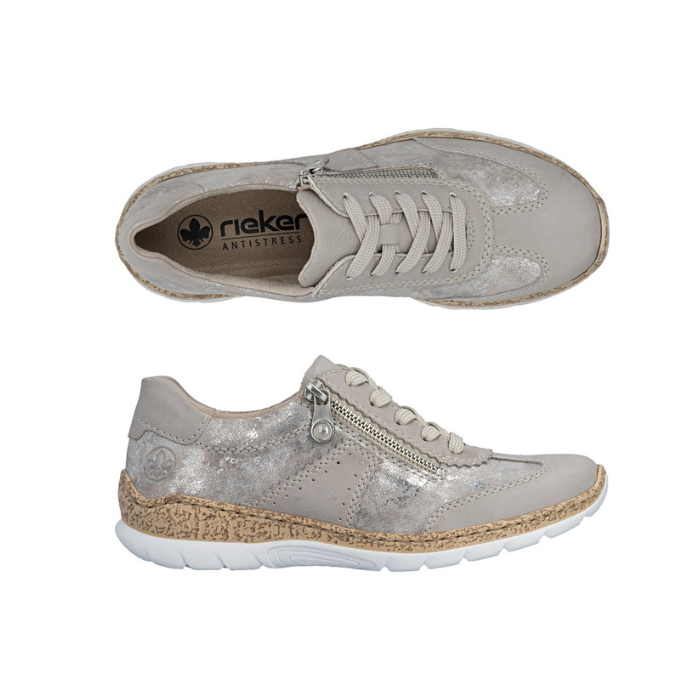 Pair of Soft beige sneakers with shimmery accent panels, lace, side zipper, tan Rieker logo'd footbed, faux cork midsole and white outsole.