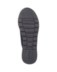 Black rubber outsole of women's sneaker with green Remonte logo on heel.