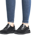 Grey lace up sneaker with low wedge outsole and side zipper closure.