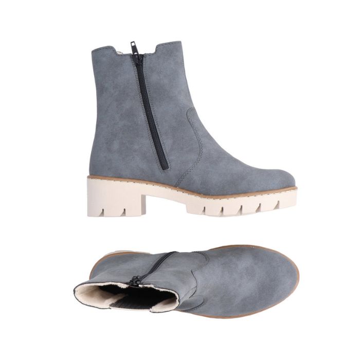 Blue Chelsea boot with platform lugged white outsole. Boot has black zipper closure.