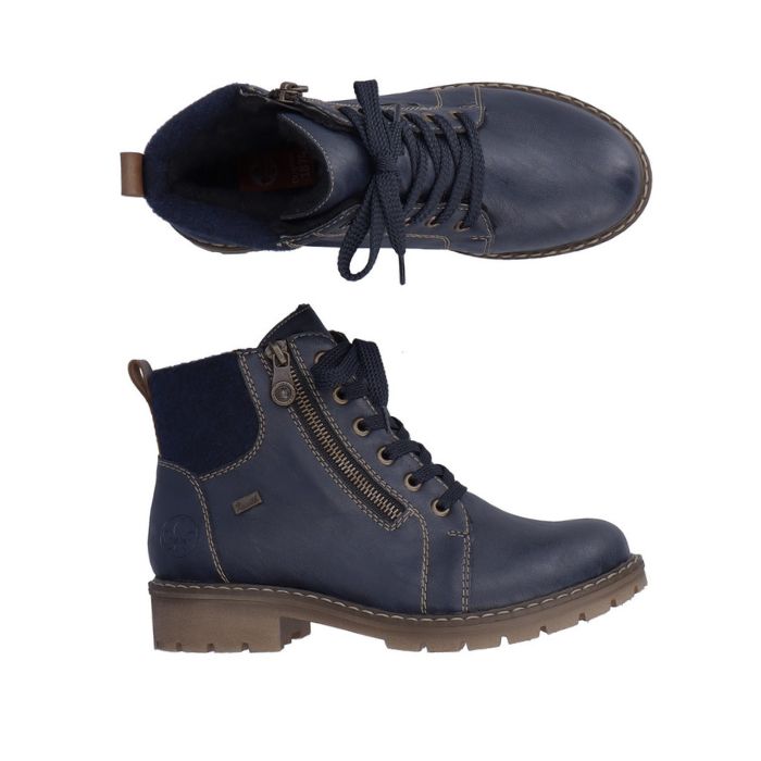 A pair of Rieker navy leather ankle boots with fabric cuff, tan accent stitching and rugged brown outsole. 