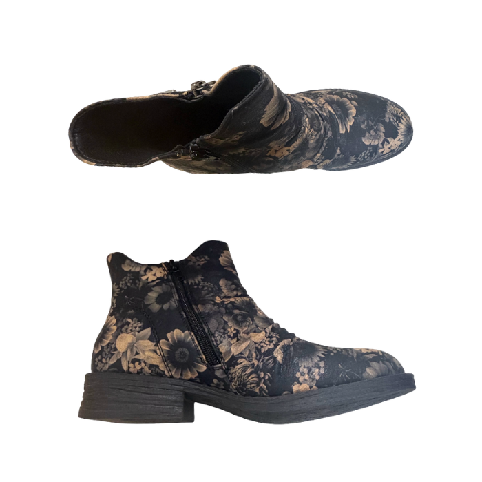 Pair of ankle boots with a dark charcoal gray base and a beige floral pattern, a side zipper on each side and a low block heel.