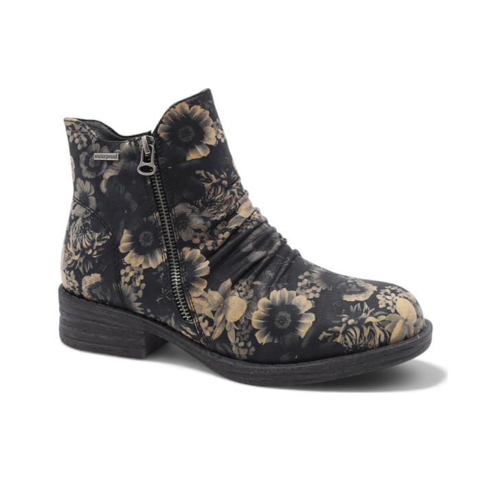 A single ankle boot with a dark charcoal gray base and a beige floral pattern, featuring a side zipper and a low block heel.