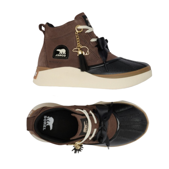Pair of brown suede platform duck boots with a black rubber toe cap, cream platform midsole, white laces, a black bow on vamp, and a gold tassel polar bear charm.