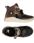 Pair of brown suede platform duck boots with a black rubber toe cap, cream platform midsole, white laces, a black bow on vamp, and a gold tassel polar bear charm.