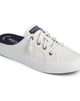 White canvas mule with laces and blue insole.