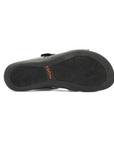 Black rubber outsole with leaf pattern tread and orange Taos logo stamped in middle.