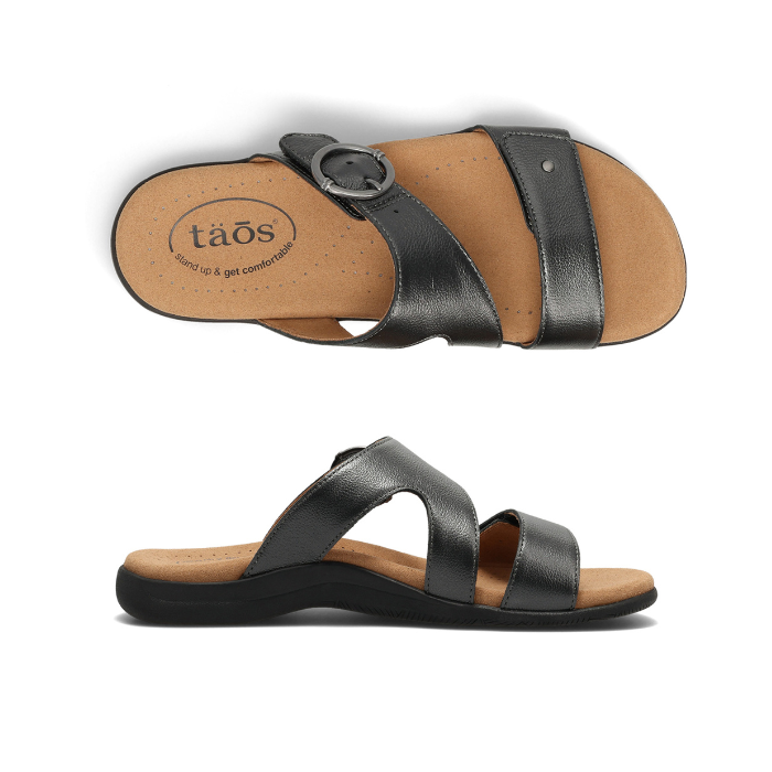Pair of Pewter metallic slide sandals with two Velcro straps, detail buckle, beige Taos logo'd footbed and black outsole.