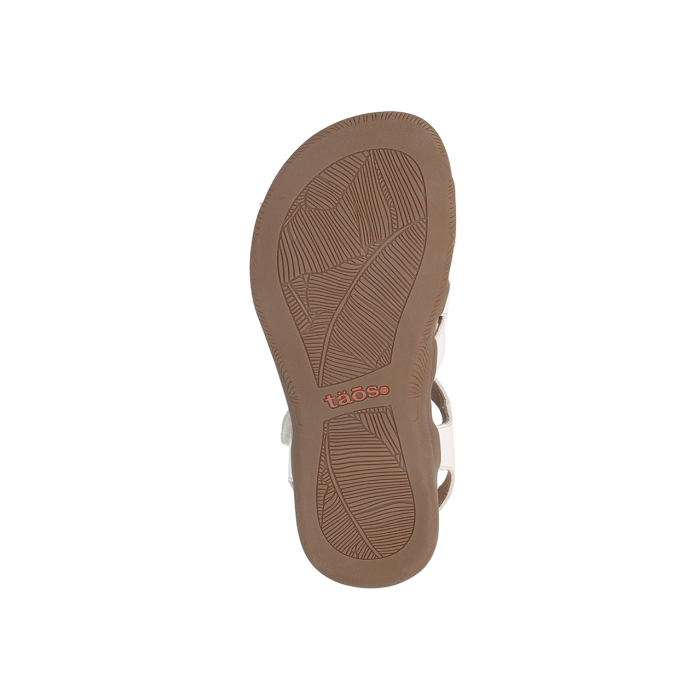 Leaf patterned tread on brown outsole with Taos logo stamped in middle.