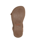 Leaf patterned tread on sandal's rubber outsole with orange Taos logo in middle.
