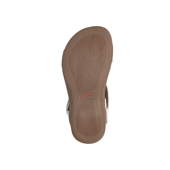 Leaf tread patterned outsole with orange Taos logo in middle.