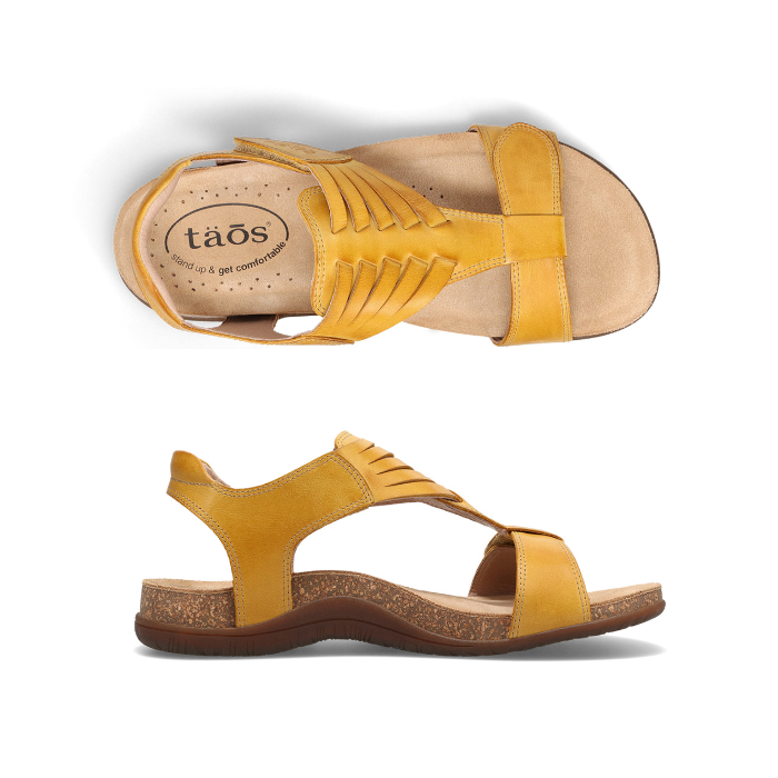 Pair of Yellow backstrap sandals with woven details on t-strap, tan Taos logo'd footbed and brown rubber outsole.