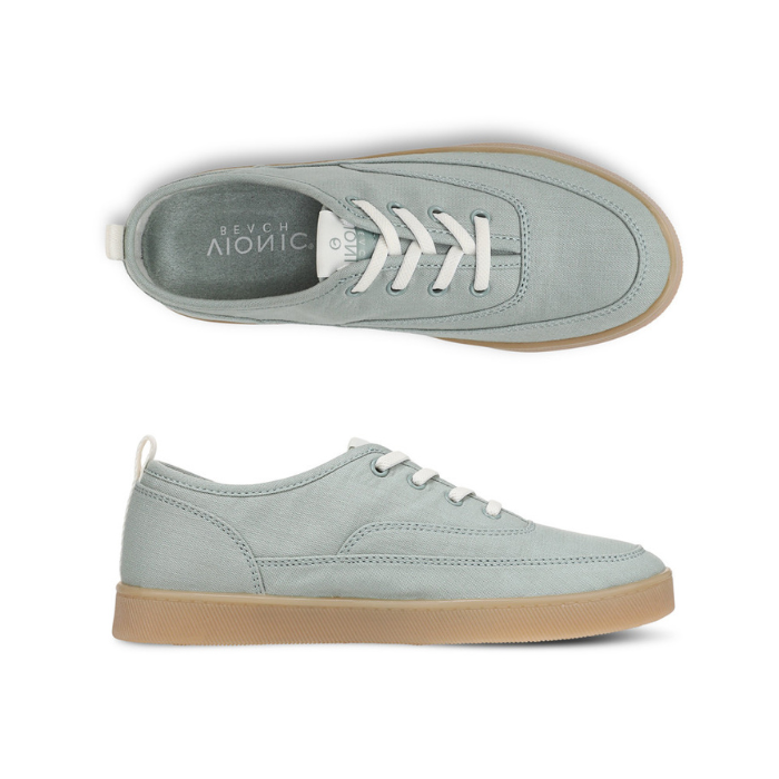 Pair of Light blue casual sneaker with white laces, light green footbed and tan outsole. 