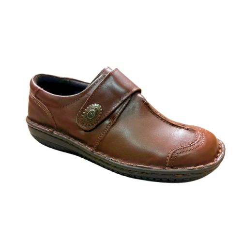 Brown slip on shoe with Velcro cross strap with metal detail and detailing stitching
