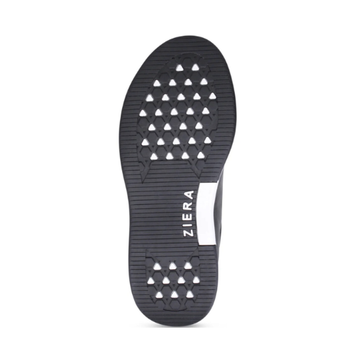 The black rubber outsole of a ZIERA shoe with a textured tread pattern in triangular cutouts and the brand name 'ZIERA' printed vertically in white.