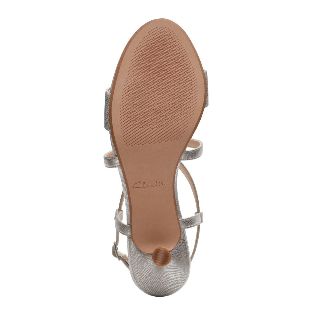 Brown rubber outsole of women's heeled sandal.