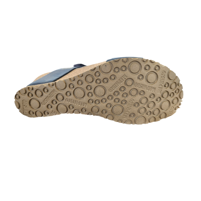 Beige outsole of wedge sandal with circle details and Mephisto logo's stamped in.