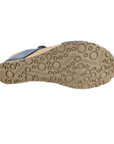 Beige outsole of wedge sandal with circle details and Mephisto logo's stamped in.