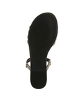 Light treaded black outsole of sparkly slide sandal.