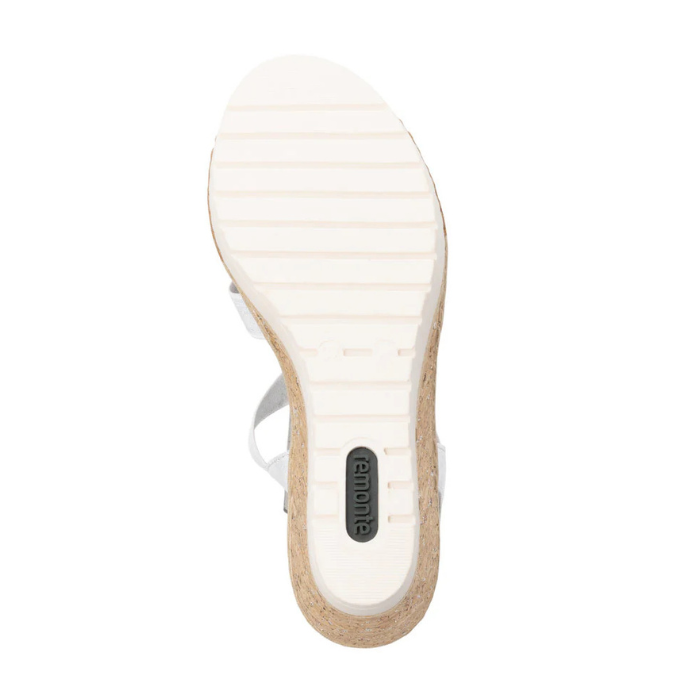 White rubber outsole with line tread pattern and green Remonte logo on heel.