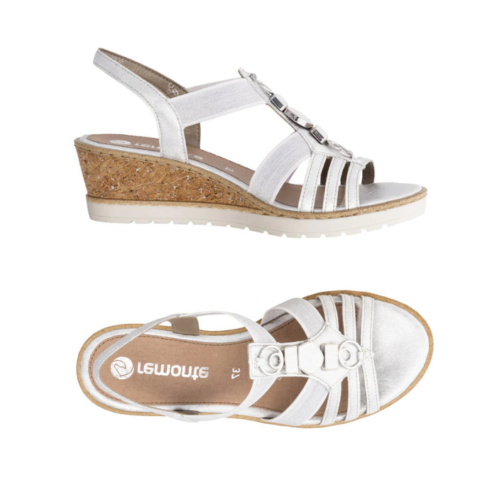 Pair of Silver slingback wedge sandals with gladiator style straps, shimmery pearled charm t-strap, tan Remonte logo'd footbed, cork wedge and white outsole.