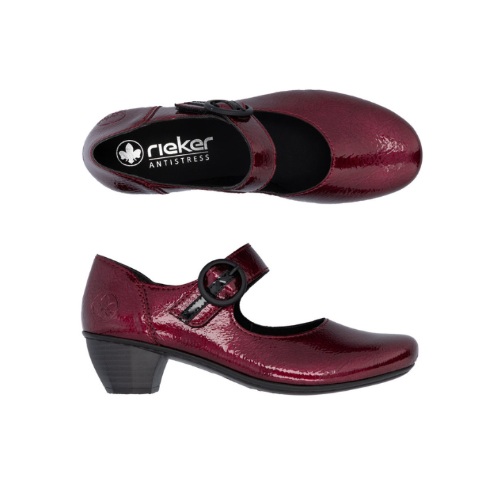 Pair of burgundy patent leather heeled shoes with a black strap buckle and black footbed with the Rieker logo.