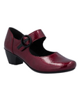 Red patent leather heeled mary-jane shoe with a black buckle.