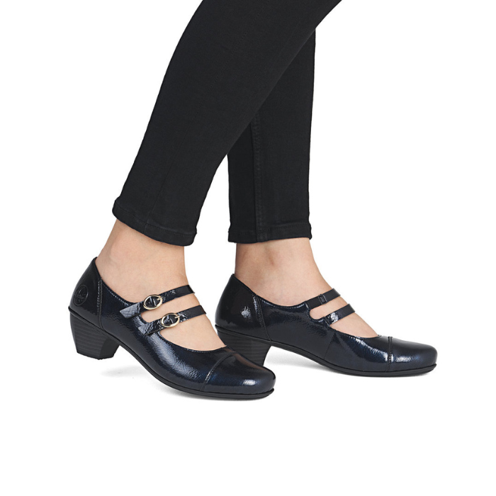 Dark navy patent Mary-jane low heel shoes worn with black pants.