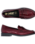 Pair of A red patent loafer with Rieker logo'd footbed and  black rubber outsole.