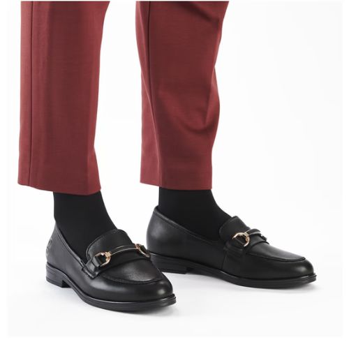Model wearing red pants with black leather loafers.